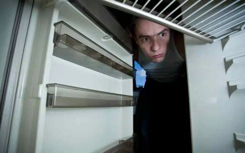 A boy looking inside the fridge